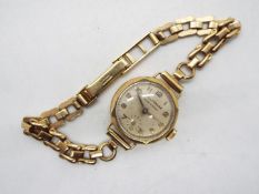 A lady's 9ct gold cased wrist watch on 9ct gold strap, 17.7 grams all in.