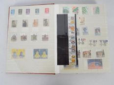 Philately - An album containing a collection of mounted mint stamps,