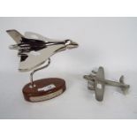 A chrome Vulcan Bomber desk ornament on wooden oval base (18 cm height) and a pewter Lancaster