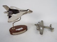 A chrome Vulcan Bomber desk ornament on wooden oval base (18 cm height) and a pewter Lancaster