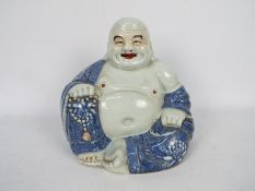 A Chinese figure of Budai, modelled in open robes,