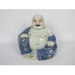 A Chinese figure of Budai, modelled in open robes,