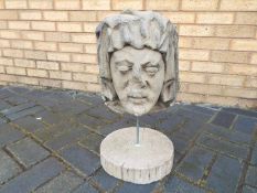 A stone head mounted to stand, recovered from a property in Alkrington, Middleton,