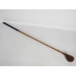 An early 20th century hickory shaft golf club by Robert Forgan St Andrews with brass sole plate,