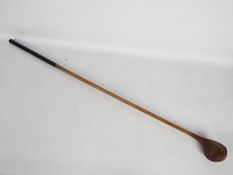 An early 20th century hickory shaft golf club by Robert Forgan St Andrews with brass sole plate,