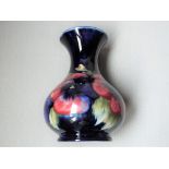 Moorcroft Pottery - a vase with flared rim,
