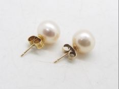 A pair of yellow metal and pearl stud earrings, stamped 375.