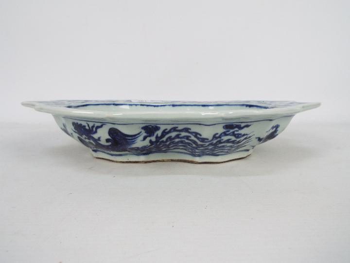 A Chinese blue and white dish decorated with phoenix amongst cloud scrolls, - Image 5 of 12