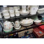 Minton - A quantity of Haddon Hall pattern dinner and tea wares comprising tureen, plates, teapot,