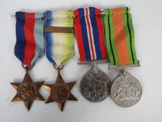 A World War Two (WW2 / WWII) group of four comprising British war Medal, Defence Medal,