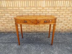 A serpentine front console table measuring approximately 84 cm x 105 cm x 48 cm.