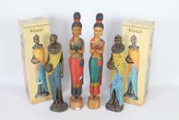 Two boxed Masai figurines by The Leonardo Collection and two Asian carved wood figures,