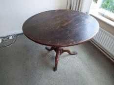 A 19th century oak round tilt-top table