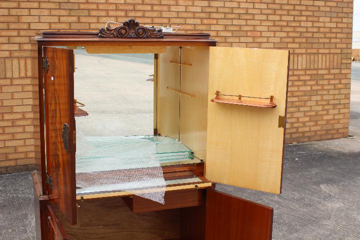 A drinks or cocktail cabinet with mirror backed interior, raise on four supports, - Image 3 of 6