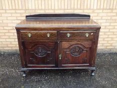 A sideboard with carved decoration measuring approximately 95 cm x 130 cm x 52 cm