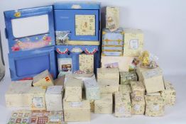 A large quantity of boxed Cherished Teddies figurines including Club Membearship year figures.