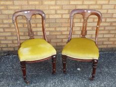 A pair of hall chairs with carved decora