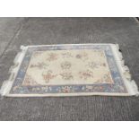 A Kayam rug with floral decoration measuring approximately 190 cm x 122 cm