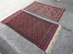 Two wall hanging carpets measuring approximately 105 cm x 185 cm and 21 cm x 117 cm.