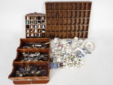 Lot to include thimbles, miniature Wedgwood ceramics, display stands, collector spoons and similar.