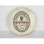 A Guinness advertising bodhran, approximately 46 cm (d).