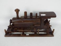 A carved wooden model of a steam locomotive, approximately 45 cm (l).