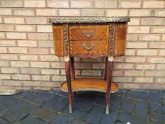 A kidney shaped, two tier, bedside or occasional table with brass gallery and twin drawers,