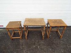 A nest of three occasional tables, largest approximately 50 cm x 53 cm x 40 cm.
