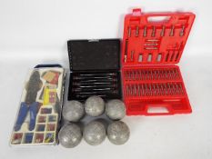 A small quantity of tools and a set of boules.
