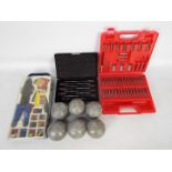 A small quantity of tools and a set of boules.