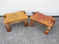 Two leather topped camel stools.