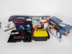 Lot to include a Bosch cordless angle grinder, Draper hot air gun, air compressor and similar.