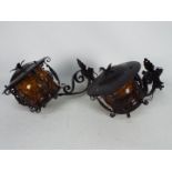 A pair of wall mountable wrought iron la