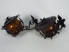 A pair of wall mountable wrought iron la