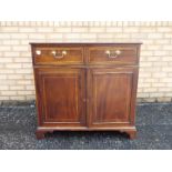 A small sideboard having two drawers ove