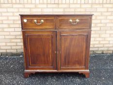 A small sideboard having two drawers ove