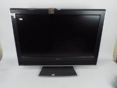 A 32" Toshiba Regza LCD television, model 32WLT66s, with remote.