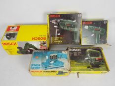 A collection of boxed Bosch power tools