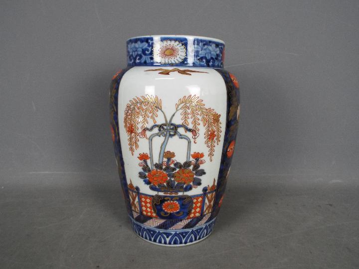 A large vase with floral and foliate decoration in the Imari palette, approximately 25 cm (h).