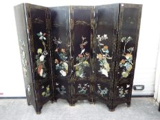 A large black lacquer, six leaf screen measuring approximately 183 cm x 240 cm.