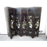 A large black lacquer, six leaf screen measuring approximately 183 cm x 240 cm.