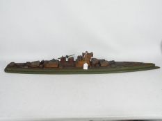 A scratch built wooden model of a battle