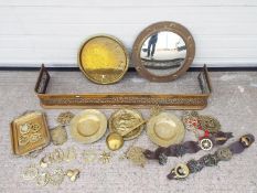 Mixed brassware including horse brasses, fire fender and similar and a circular wall mirror.