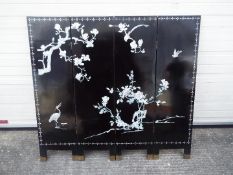 A four leaf black lacquer screen measuring approximately 122 cm x 132 cm.