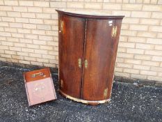 A bow front corner cabinet, approximatel