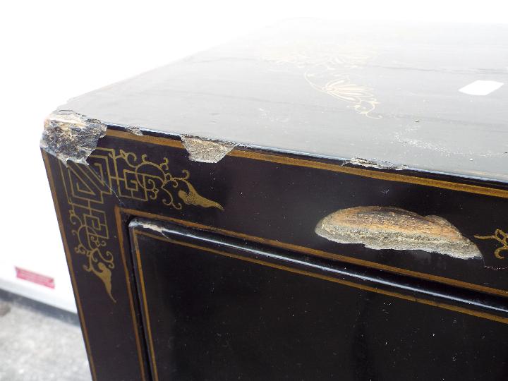 A twin door black lacquered cabinet decorated with perching birds, - Image 6 of 7