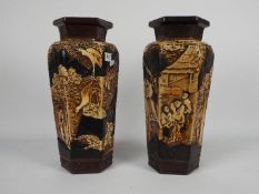 A pair of Bretby Pottery hexagonal section vases with Oriental style decoration,