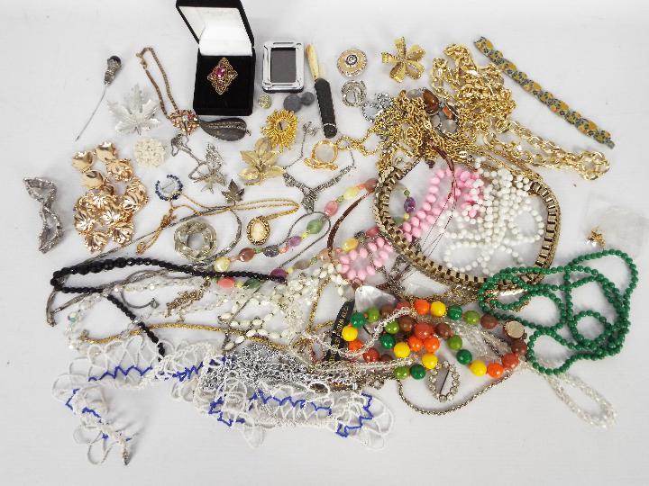 A collection of costume jewellery to include brooches, necklaces, bracelets and similar.