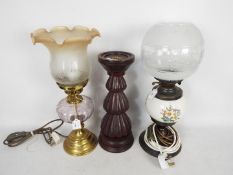 Two converted oil lamps and a candle holder.
