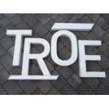 Decorative wall art - a group of metal letters painted white,